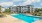 a large white building with a pool
