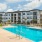 a large white building with a pool