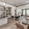 a large kitchen with a bar and dining table